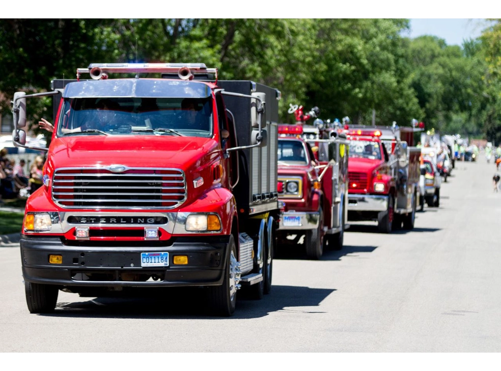 Red trucks lined up for a parade.